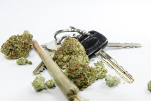 A pile of cannabis flowers and car keys. Learn about marijuana DUIs in California now. 