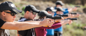 young people learning how to use a firearm