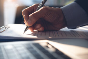 A man fills out paperwork to apply for a restricted license after a DUI. A DUI lawyer in Los Angeles will protect your rights.