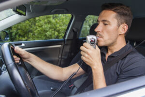 A man blows on a breathalyzer. Do I have to get an interlock device if I don’t own a car?