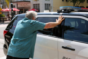 A man getting arrested for a DUI puts his hands on a police car and wonders, “How bad is a DUI?” 