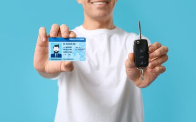 A happy man holding his license. You can find out how to get a hardship license in California with a legal professional.