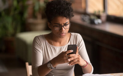 A woman using her phone to research if a wet reckless affects employment. 